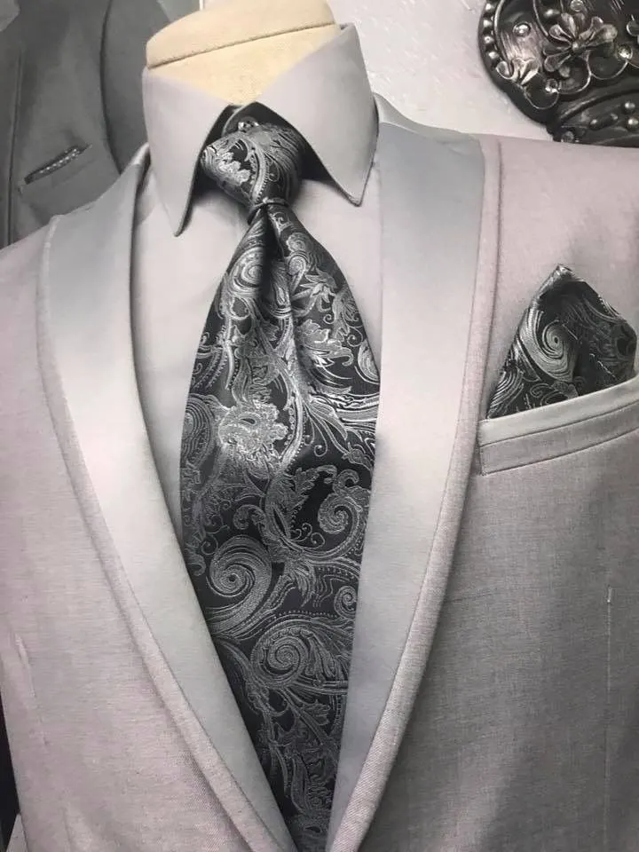 A light grey suit with a paisley tie